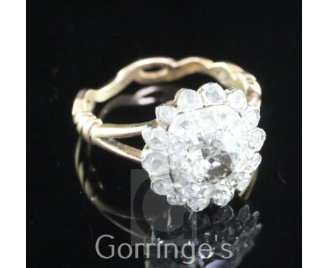 A 19th century gold, silver and diamond cluster ring, set with rose and old mine cut stones, size K.