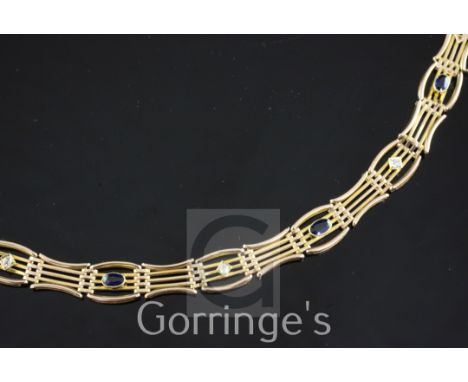An Edwardian 15ct gold, sapphire and diamond gate link bracelet, set with three oval cut sapphires and three round cut diamon