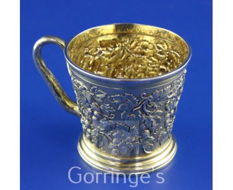 PAUL STORR. A good William IV silver gilt christening mug, of tapering cylindrical form, with rustic handle and embossed with