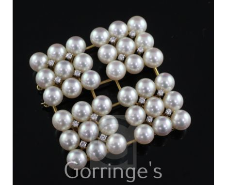 An 18ct and 14ct gold, cultured pearl and diamond pendant, of open work diamond shape, with four diamond shaped clusters, eac