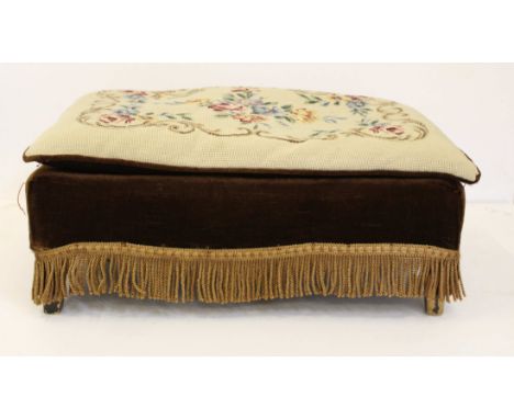 A low rectangular footstool, upholstered in brown draylon with floral tapestry cushion top, 28 x 61 x 41cm