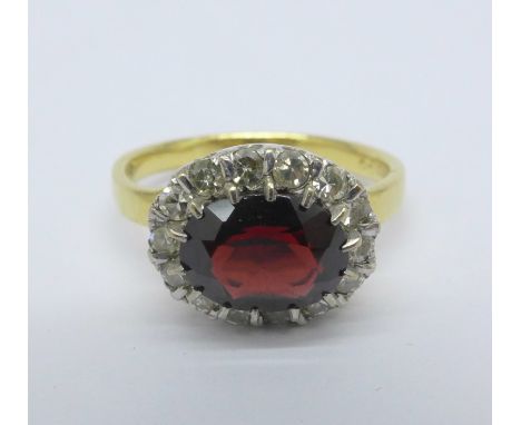 An 18ct gold, garnet and diamond ring, 3.9g, M