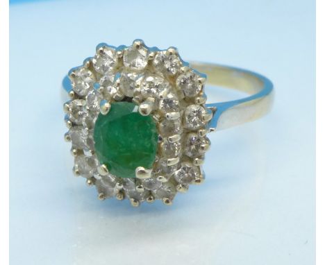 A white metal set, emerald and diamond cluster ring, 4.6g, P