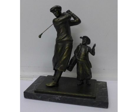 A spelter golfer and caddy on a marble base, 24cm