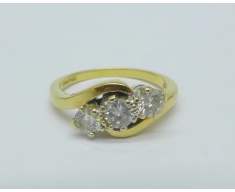 An 18ct gold, three stone diamond ring, '50 pts' stamped on shank, 3.6g, L