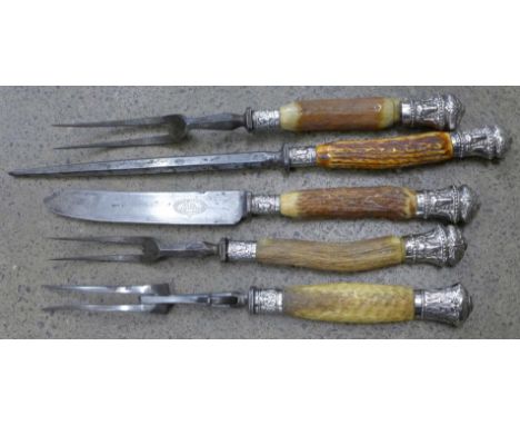 A four piece silver mounted carving set and one other fork, one fork a/f