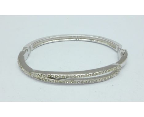 A pair of Swarovski earrings and a Swarovski bangle