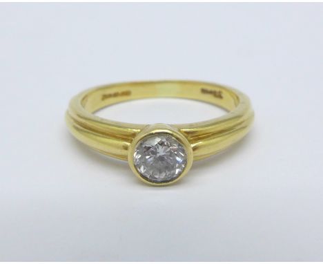 An 18ct gold and diamond solitaire ring, '33pts' stamped on shank, 3.4g, J