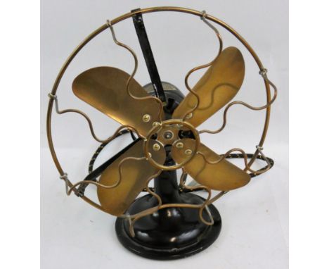 A vintage electric desk fan, with brass oscillating blades and guard, No. 3227875.  