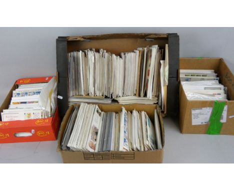 Four boxes containing a substantial amount of First Day Covers, circa 1970 - 1990's, together with Royal Mail Mint stamp issu