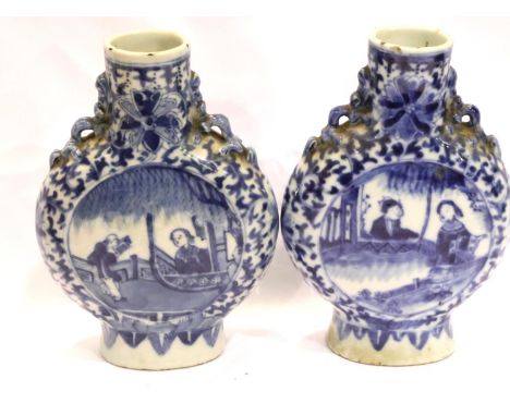 Pair of Chinese blue and white ceramic moon flasks with applied decoration, each H: 16 cm. Crack to rim on one of the vases, 