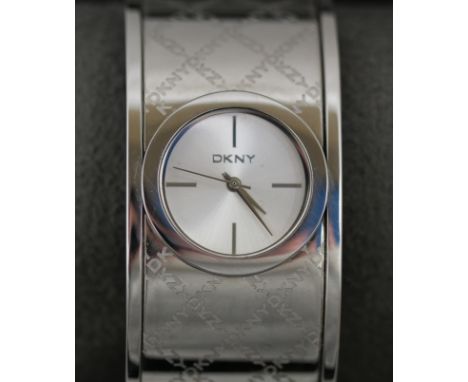 A ladies DKNY bangle watch with working quartz movement & original box (damaged) 