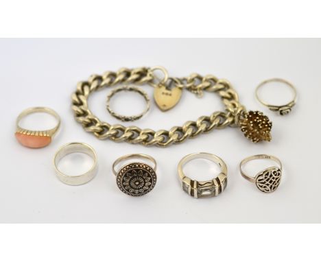 POLICE >A quantity of silver jewellery to include a padlock charm bracelet and seven rings, approx gross weight 64.2g. [NO RE