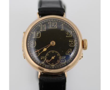 A 9ct H/M 'trench' watch with black enamel dial, working unsigned movement & fitted leather strap, import H/M Glasgow 1924