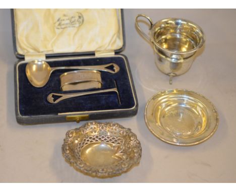A cased silver three piece christening set 'Man in the Moon' H/M Birmingham 1929, a silver cream jug H/M Chester 1908 and two