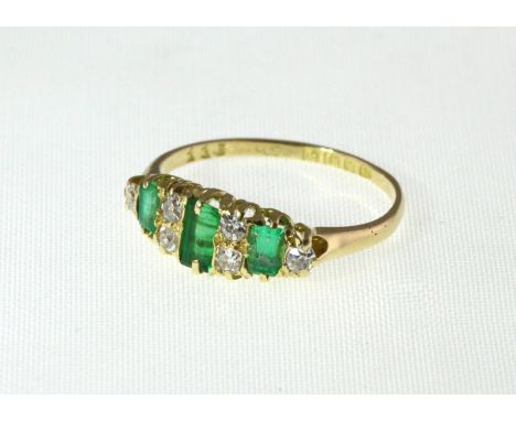 An 18ct Emerald & Diamond nine stone ring, H/M London 1913, approx 2.6g, size P