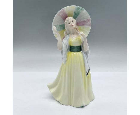 Stunning figurine in yellow dress with a green sash and a green shoe peaking out at the bottom. She is holding a multi-colore