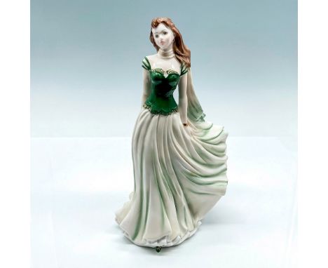 A glazed figure of a young woman in a green shirt with a long flowing white skirt that has green accents. Royal Worcester bac
