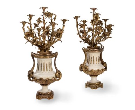 A PAIR OF FRENCH MARBLE AND ORMOLU SEVEN LIGHT CANDELABRACIRCA 1860Scrolling lily and floral branches above campana bases wit