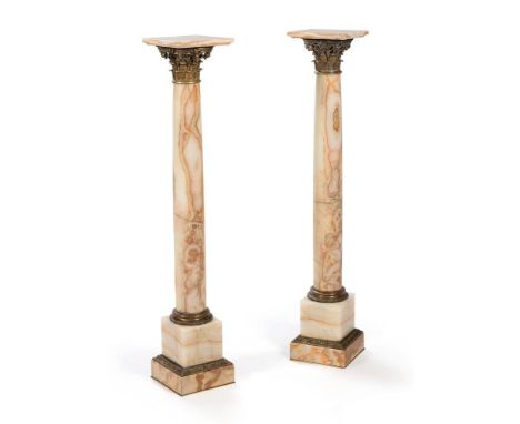 A PAIR OF FRENCH GILT METAL MOUNTED ONYX PEDESTAL COLUMNSLATE 19TH/ EARLY 20TH CENTURYEach tapering pillar surmounted by a Co