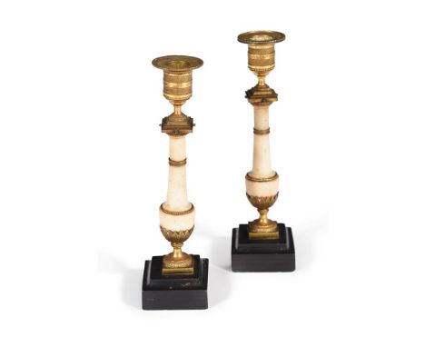 A PAIR OF GEORGE III WHITE MARBLE AND GILT METAL MOUNTED CANDLESTICKS  IN THE FRENCH MANNER, CIRCA 1810each 24.7cm highCondit