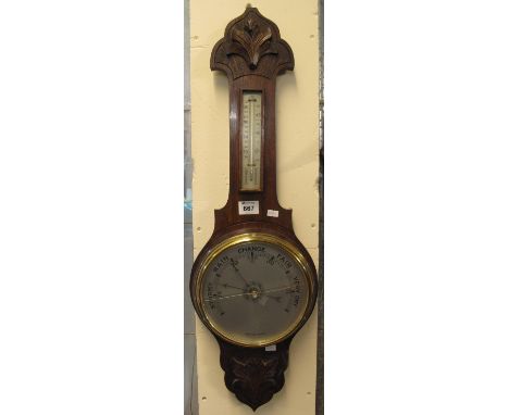 20th Century carved oak wheel barometer. (B.P. 24% incl. VAT)