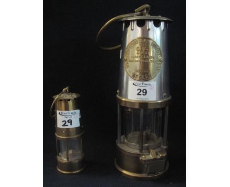 Protector lamp and lighting company Ltd brass miner's safety lamp (unused), together with a miniature brass miner's safety la