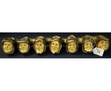 Ceramic hanging candle holder or pipe rack in the form of the faces of seven monks. 50cm wide approx.(B.P. 24% incl. VAT)