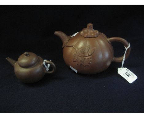 Two Chinese Yixing style terracotta pottery globular or melon shaped teapots, the tiny pot with square seal mark to base, the