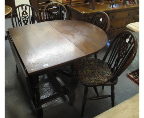 Mid 20th Century oak gate leg table, together with a set of  four wheel and spindle back chairs. (5)(B.P. 24% incl. VAT)