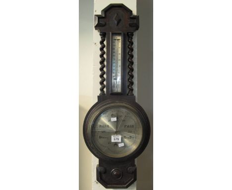 20th Century oak wheel barometer with barley twist supports. (B.P. 24% incl. VAT)