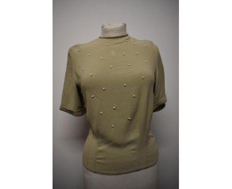 A 1950s sage green crepe blouse, having button back fastening, shoulder pads and white beading to bodice and Henri model labe