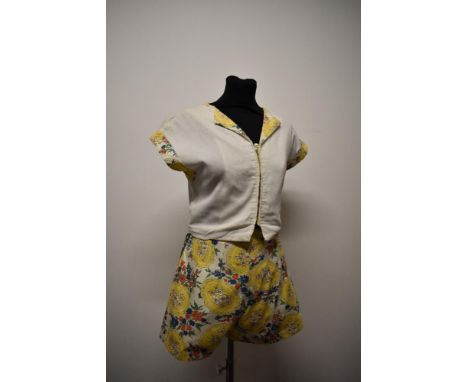 A 1940s two piece sun set in textured cotton, comprising shorts with yellow floral design and side metal zip and button, and 