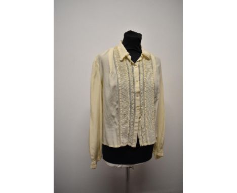 A 1940s cream long sleeved blouse.