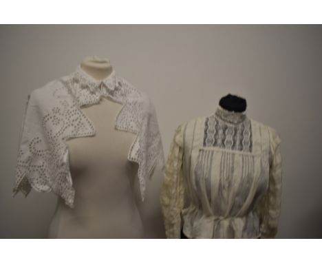 An Edwardian silk blouse, having high lace collar and tucks to sleeves, sold with a white cotton cut work cape.