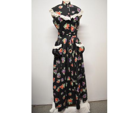 A wonderful vintage 1940s novelty fruit print cotton maxi dress, having full circle skirt, gathered patch pockets with lace e