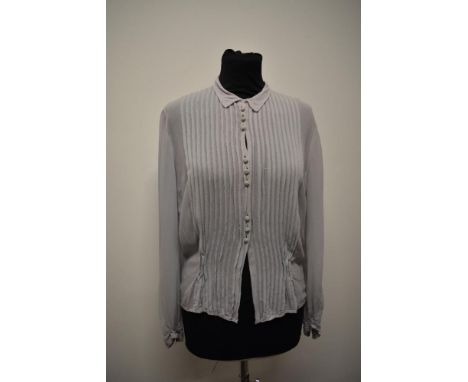 A pale blue semi sheer blouse, having tucks to front and self covered buttons and long sleeves with button to cuff.