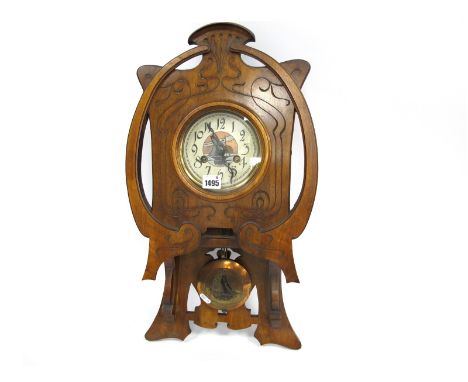 An Early XX Century Wall Clock in the Art Nouveau Style, the walnut case carved with sinuous lines, the metal dial with Arabi