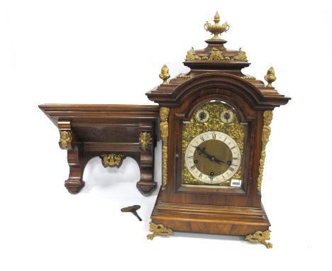 A Late XIX/Early XX Century German Large Walnut Cased Bracket Clock, with painted gilt metal mounts, the arched top with silv