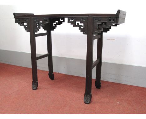 A Chinese Hardwood Altar Table, with panelled top and pierced brackets on scroll feet, 82cm high, 113cm wide.