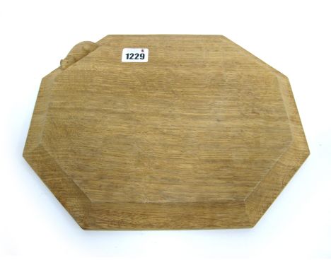 A Robert Thompson (Mouseman) Bread Board, of elongated octagonal form with carved mouse signature, 25 x 30cm, a shaped piece 