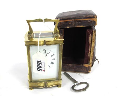 An Early XX Century Brass Cased Carriage Clock, with cream enamel face (cracked) with black Roman numerals, 15cm high handle 