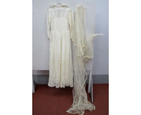 A Circa 1940's/50's Cream Lace Wedding Dress, with stand-up statement collar and button fastening to back, with veil (faults)