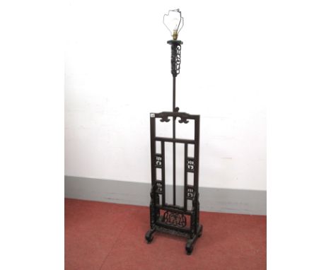 A Chinese Hardwood Extending Standard Lamp, with green shade, the base with pierced decoration on scroll feet, 172cm high.