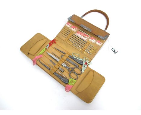 An Early XX Century Leather Cased Sewing Set, with hallmarked silver mounts and carrying handle, folding out to reveal packet