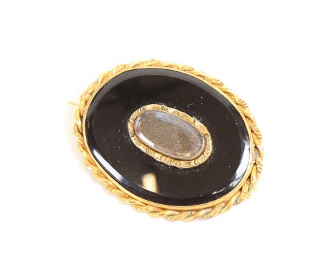 A Victorian gilt-metal and onyx mourning brooch, with woven hair panel and rope twist surround, length 4.5cm 