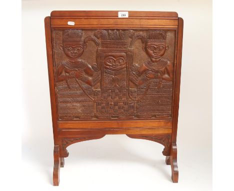 An African Tribal carved hardwood firescreen, figural and Queen Mother decoration, H70cm, W54cm 