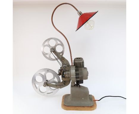 A Vintage electric film projector, complete with lamp with red enamel shade 