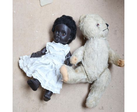 A straw-filled teddy bear, 34cm, and a Vintage doll 