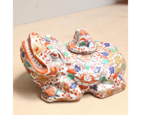 A large Oriental Imari style ceramic toad/frog, with baby toad stopper and allover floral decoration, length 25cm 